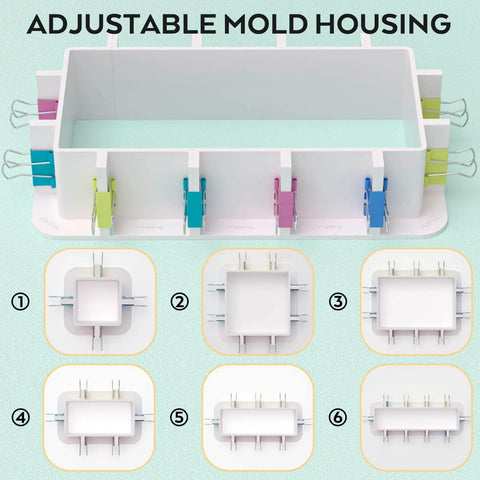 Top view of adjustable mold housing with reusable plastic frame, binder clips, and tape, ideal for DIY candle making and resin molds setup.
