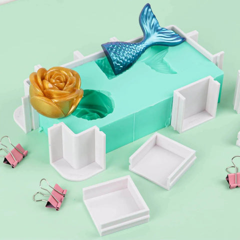 Adjustable Molds Housing For Silicone And Resin Molds shown with reusable plastic frame, binder clips, and decorative mold pieces.