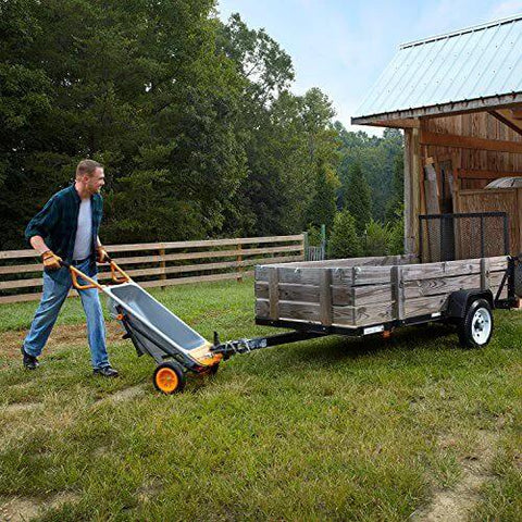 Man using 8 in 1 Heavy Duty Aerocart Garden Cart Wheelbarrow Dolly with Turbo Lift Design and Flat Free Tires to haul trailer