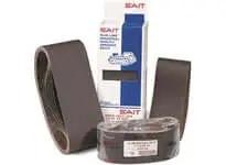 Abrasive sanding belts and packaging box, with brown belts in different rolled sizes, suitable for industrial sanding applications.