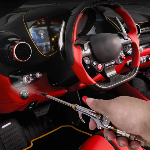 Hand using 13-Piece 2-Way Air Nozzle Kit with Quick Connects inside red car interior for efficient cleaning.