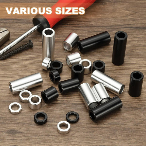 Assorted aluminum spacers in black and silver, unthreaded, various sizes, including 12 Pack Aluminum Spacers For Quarter Inch Screws Durable Aluminum Build One Quarter Inch Inner Diameter One Half Inch Outer Diameter One And A Half Inches Long Unthreaded Standoff Bushings Black Finish, with tools in background.