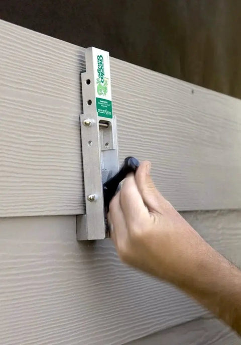 Aluminum Gecko Gauge for fiber cement siding offers precise height and spacing with a hands free mounting tool in use on siding board.