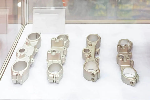 Precision machined metal parts on display in a glass cabinet