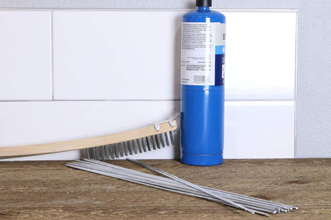 USA Made Aluminum Repair Brazing Rods Set by Alumaloy, 20 Rods shown with torch and brush on wooden surface