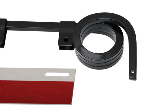 Close-up of angled mud flap hanger with three-coil damping spring and reflective plate, black powder coating, and E coating.