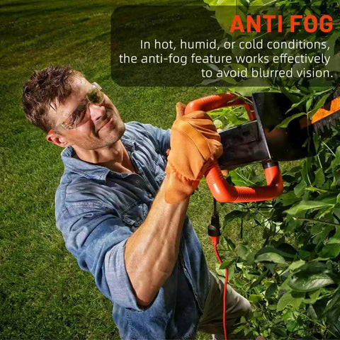 Man wearing Anti Fog ANSI Z87.1 Safety Glasses for Construction and Woodworking Unisex, using hedge trimmer outdoors in garden.
