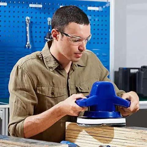 Man wearing Anti Fog Safety Glasses 12 Pack With UV Protection And Scratch Resistant Lenses using power sander in workshop