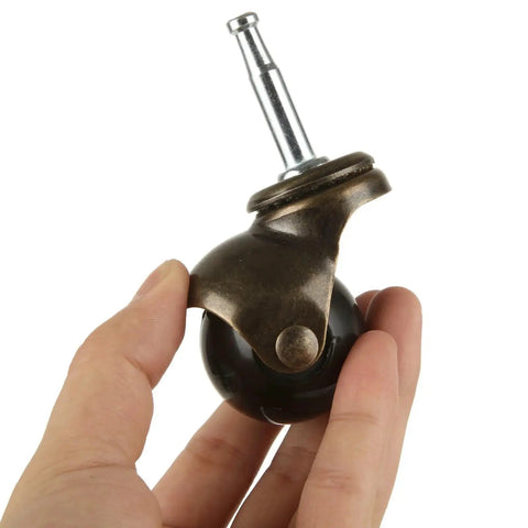 Close-up of antique copper-finish caster wheel with 1.6-inch ball and mounting stem from One Point Six Inch Ball Caster Wheels 8 Pack For Furniture Chairs Sofas And Cabinets With Swivel 360 Degree Mounting Stem Socket Five Sixteenth By One And One Half Inch Durable Antique Style Casters Each Wheel Supports Up To Thirty Pounds And Is Suitable.