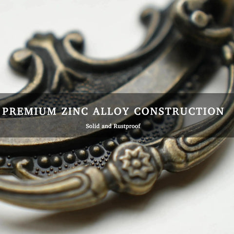 Close-up of Antique Brass Baroque Style Drop Bail Drawer Pull with ornate curves and floral accents in zinc alloy construction.