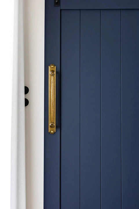 Antique Brass Drawer Pulls With Backplate Center To Center Five Point Zero Four Inches installed on a blue cabinet door