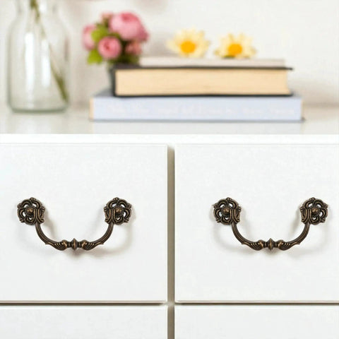 4-Pack Antique Brass Drawer Pulls 4.5 Inch Center-to-Center Drop Bail Dresser Handles shown on white dresser