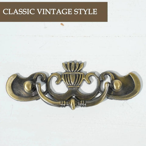 Antique Brass Drop Bail Drawer Pulls Six Pack With Two And A Half Inch Hole Centers, decorative furniture hardware close-up.