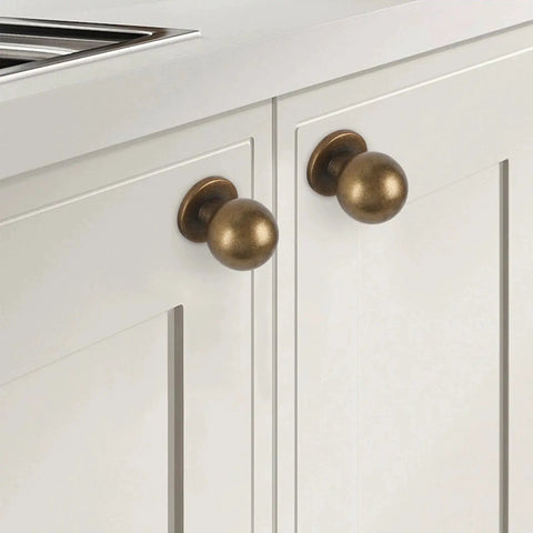 Antique Brass Kitchen Cabinet Knobs Set Of 10 For Solid Wood And Metal Drawers shown installed on white cabinet doors