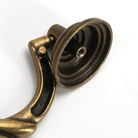 Close-up of 4.5 Inch Center To Center Antique Bronze Drawer Pull showing detail of bail drop swing handle and mounting point.