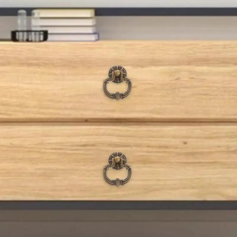 Vintage Drop Ring Pulls Set of 4 in Antique Bronze on wooden dresser in bedroom