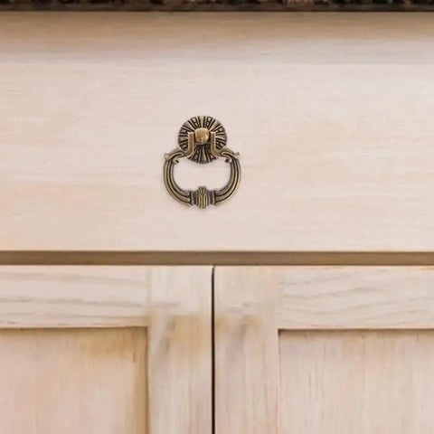 Vintage Drop Ring Pulls Set of 4 in Antique Bronze for cabinets installed on light wood wardrobe.