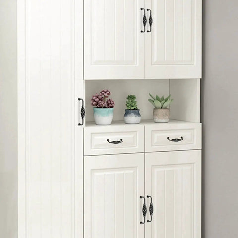Four Pack Birdcage Style Cast Iron Antique Cabinet Hardware Handles With Center Hole Mount installed on white kitchen cabinets.