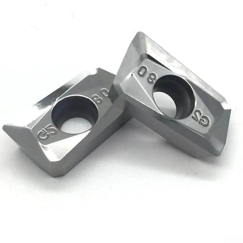 Close-up of two APKT1604PDFRG2 carbide inserts for aluminum finishing and semi-finishing, wear resistant for non-ferrous metal machining.