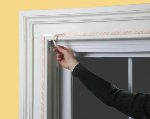 Applying Indoor Shrink Window Kit For Large Windows And Patio Doors 84 Inch By 110 Inch Clear Film to window frame