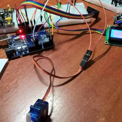 2Pcs SG90 Micro Servo Motor 180 Degree SG90 9G Gear Motor Control connected to Arduino setup on a wooden table