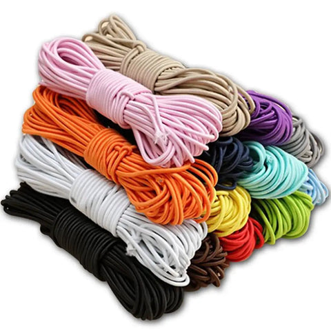 Multicolor bungee shock cord ropes stacked, various colors including black, showcasing One Eighth Inch By Fifty Foot Bungee Shock Cord Rope Marine Grade Heavy Duty Polyester Bungie Elastic Stretch String For Kayak Straps Tarp Tie Downs Canopy Boating Camping Tent Crafting Patio Black