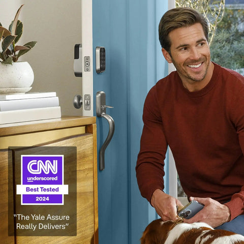 Man with dog near Assure Lock 2 Deadbolt With WiFi Keypad For Smart Home Entry Code Entry And Remote Access Keyless Entry Via Keypad And App Auto Lock And DoorSense Fits Doors By Replacing A Standard Deadbolt Easy Installation For Remote Access And WiFi Connectivity