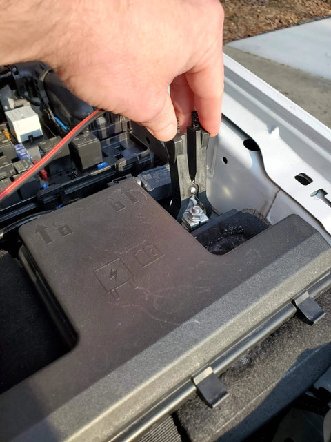 Automotive Relay Tester With Puller For 12V Cars And Trucks in use, testing car electrical system with battery clips.