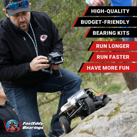 Man controlling RC truck with Axial SCX6 Trail Honcho Sealed Bearing Kit Upgrade With FastEddy Bearings on rocky terrain