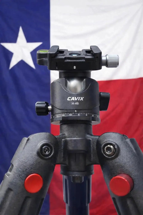 Front view of Ball Head Mount Adapter For BOG DeathGrip Tripod With Arca Swiss Plate and hardware against a Texas flag backdrop.