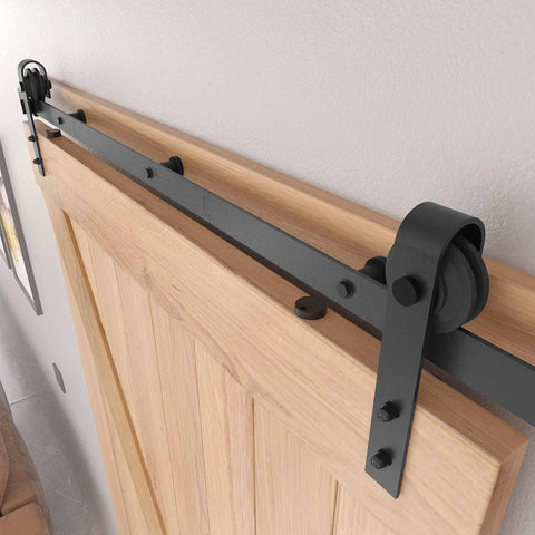 Close-up of 8FT Barn Door Hardware Kit with Heavy Duty Sliding Track, J Shaped Carbon Steel System on wooden interior door.