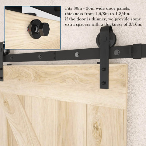 Close-up of black J-shaped roller on 6.6FT Barn Door Hardware Kit with Heavy Duty Modular Sliding Track installed on wooden door panel.