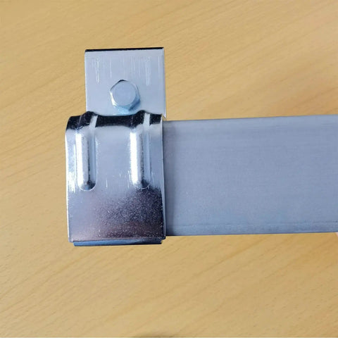 Close-up of galvanized steel heavy duty box rail hanger bracket for barn doors exterior hardware with bolt and bendable tab.