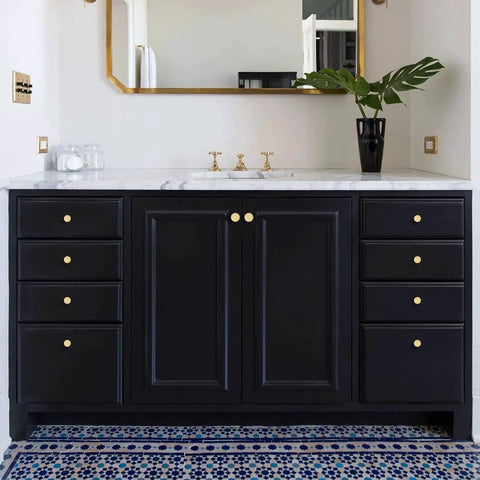 Solid Brass Brushed Gold Cabinet Knobs Set on black bathroom vanity with marble top