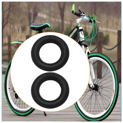 Black bicycle with focus on two replacement rubber wheels for smooth rolling on wooden path.