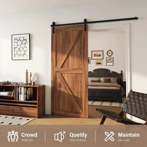 J Shape 4 Foot Barn Door Hardware Kit For Single Sliding Door In Black Carbon Steel Heavy Duty Track System With Easy Install For 29 Inch Closet Panel Supports Door Weight Up To 277 Lbs installed in a living room setting.