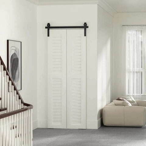 Installed 36" Bi-Folding Sliding Barn Door Hardware Track Kit, side mounted black roller, in a modern living room setting, door not included