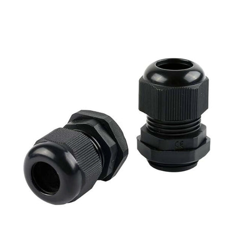 Close-up of two black plastic cable glands, one oriented upright and the other on its side, showing threaded material and opening.