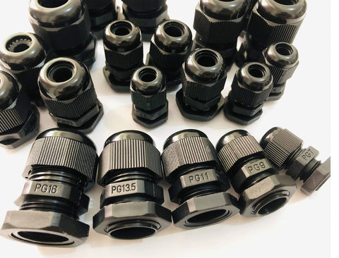 Close-up of multiple black cable gland connectors of various sizes, labeled PG16, PG13.5, PG11, PG9, for electrical applications.