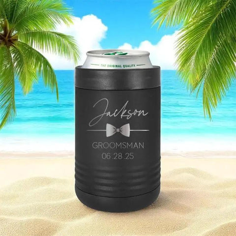 Custom Engraved Stainless Steel Can Cooler For 12 Oz And 16 Oz Cans, Vacuum Insulated With Anti Slip Grip, Keeps Drinks Ice Cold For Hours, Perfect Wedding Party Gift For Groomsmen And Bridesmaids, For The Whole Crew, Black, on a beach setting.