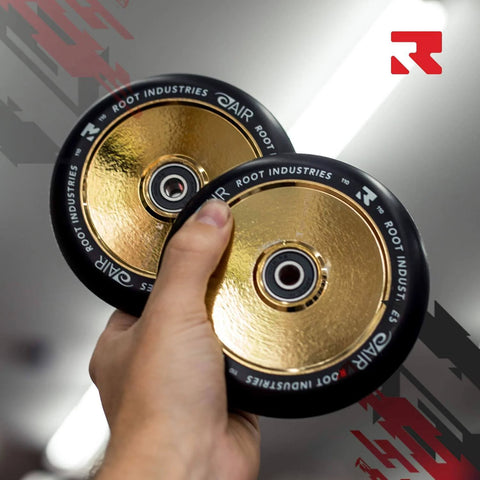 Person holding 110mm AIR Scooter Wheels Black Gold Lightweight Durable Pro Scooter Wheels Designed for Smooth Control Easy Installation