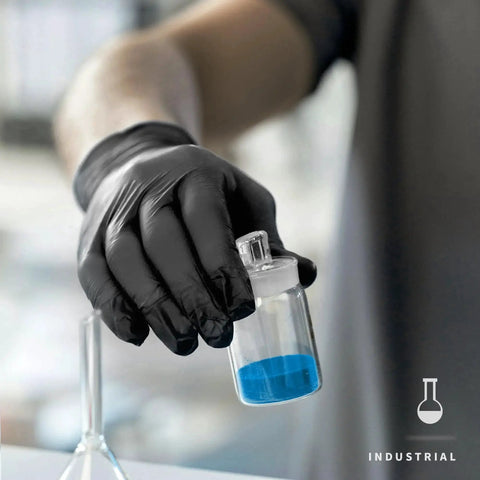 Person wearing Black Nitrile Disposable Gloves 4.5 Mil Powder Free Latex Free Food Safe Exam, holding a container in a lab.