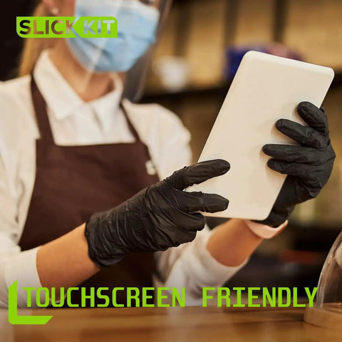 Person wearing Black Nitrile Gloves 4 Mil Latex Free Powder Free Large Pack Of 100 using a tablet, showcasing touchscreen compatibility.