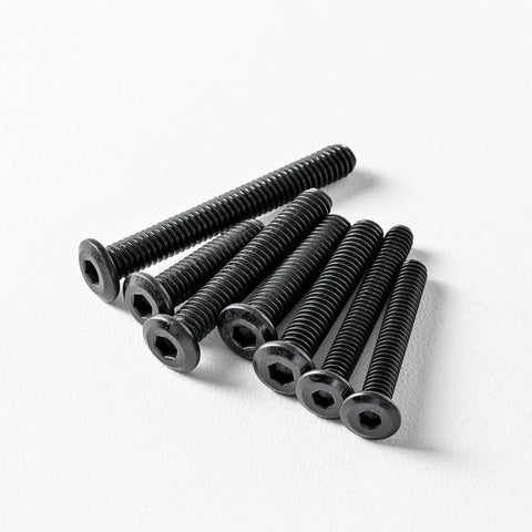 Pack of Quarter Twenty Flat Head Hex Socket Cap Screws Bolts Three Quarter Inch Black Oxide 304 Stainless Steel on white surface