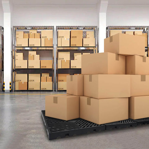 Six Pack Black Plastic Pallets For Basement Storage Lightweight HDPE Pallets With Breathable Grid For Waterproof Organization And Outdoor Pet Cushion Measures 15.7 By 15.7 By 1.18 Inches Each in warehouse setting with stacked boxes.