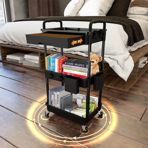 Side view of a black 3 Tier Rolling Utility Cart With Drawer On Wheels For Kitchen Bathroom Living Room And Office Must Have Space Saving Multi Functional Storage Organizer Black By REBECAT, shown in a bedroom.
