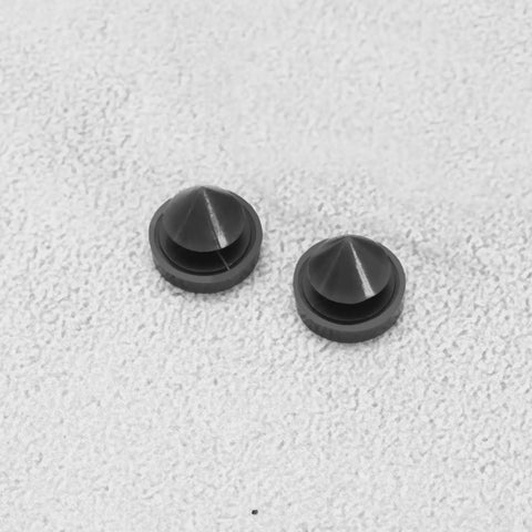 Close-up view of 100 Pcs Rubber Door Silencers For Metal Frame Doors Anti Slam Hinge Outlet Cushions on grey surface