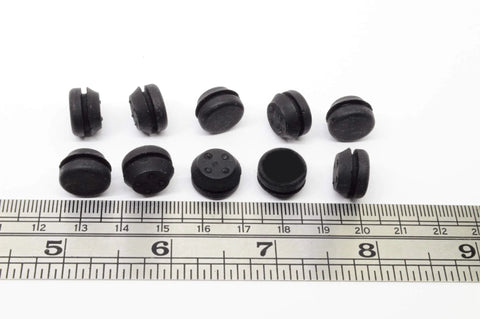 Black SBR rubber push-in bumpers, 1/2 inch diameter, 1/8 inch height, next to ruler, pack of six, surface protection, withstands -20 to 180°F.