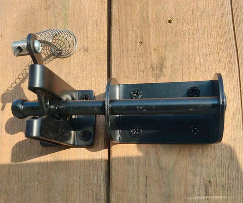 Self Locking Gate Latch For Outdoor Fences In Black Steel With Automatic Gravity Lever Lock Installed on Wooden Gate