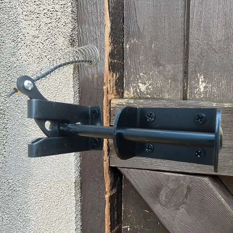 Self Locking Gate Latch For Outdoor Fences In Black Steel With Automatic Gravity Lever Lock Installed on Wooden Gate